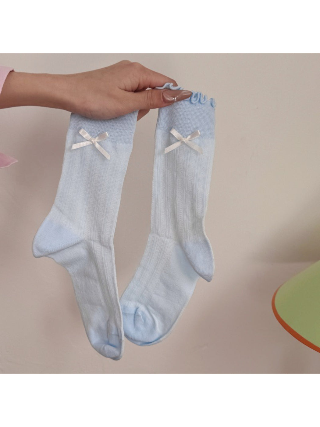 Rufia socks folded neatly to showcase the soft texture and bow embellishment