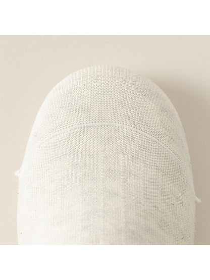 Model wearing light gray Rufia ribbed mid-calf socks paired with sneakers