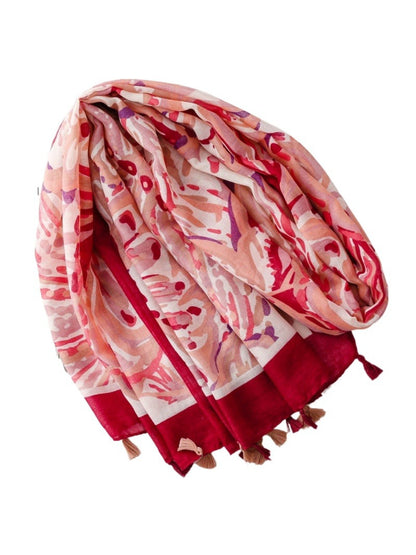 Model wearing Scarvii Coral Border Lightweight Scarf draped around neck with coral border visible