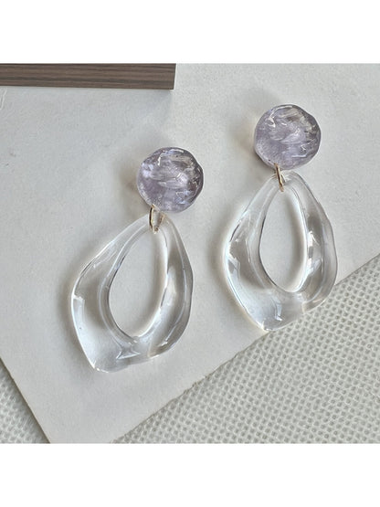 Earwish clear teardrop hoop earrings displayed hanging on a stand