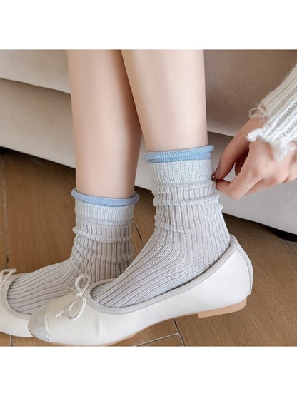 Rufia ribbed crew socks folded to display pastel yellow contrast trim