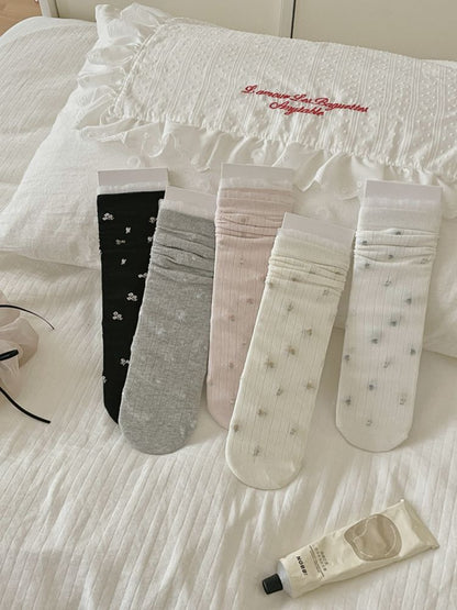 Rufia crew socks displayed flat showing full ditsy bow pattern