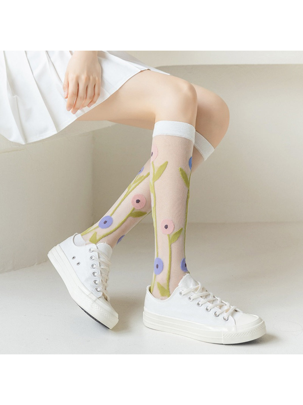 Close-up of Rufia Bloom mesh knee high socks showing floral pattern detail