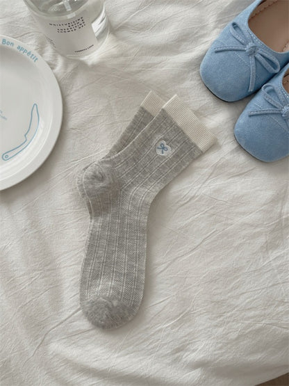 Top view of Rufia floral knit crew socks showing ribbed cuff and floral pattern