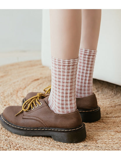 Rufia knit crew socks styled with rolled-up pants and sneakers
