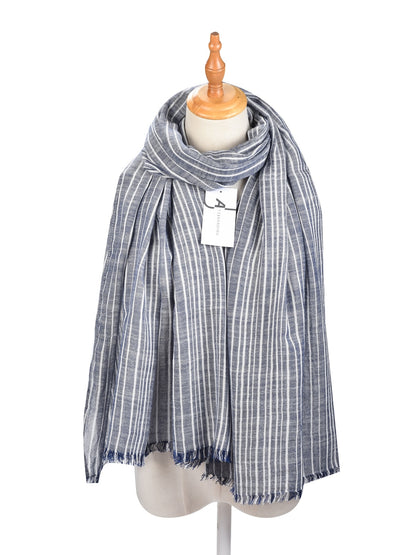 Model wearing Scarvii striped lightweight scarf draped around neck
