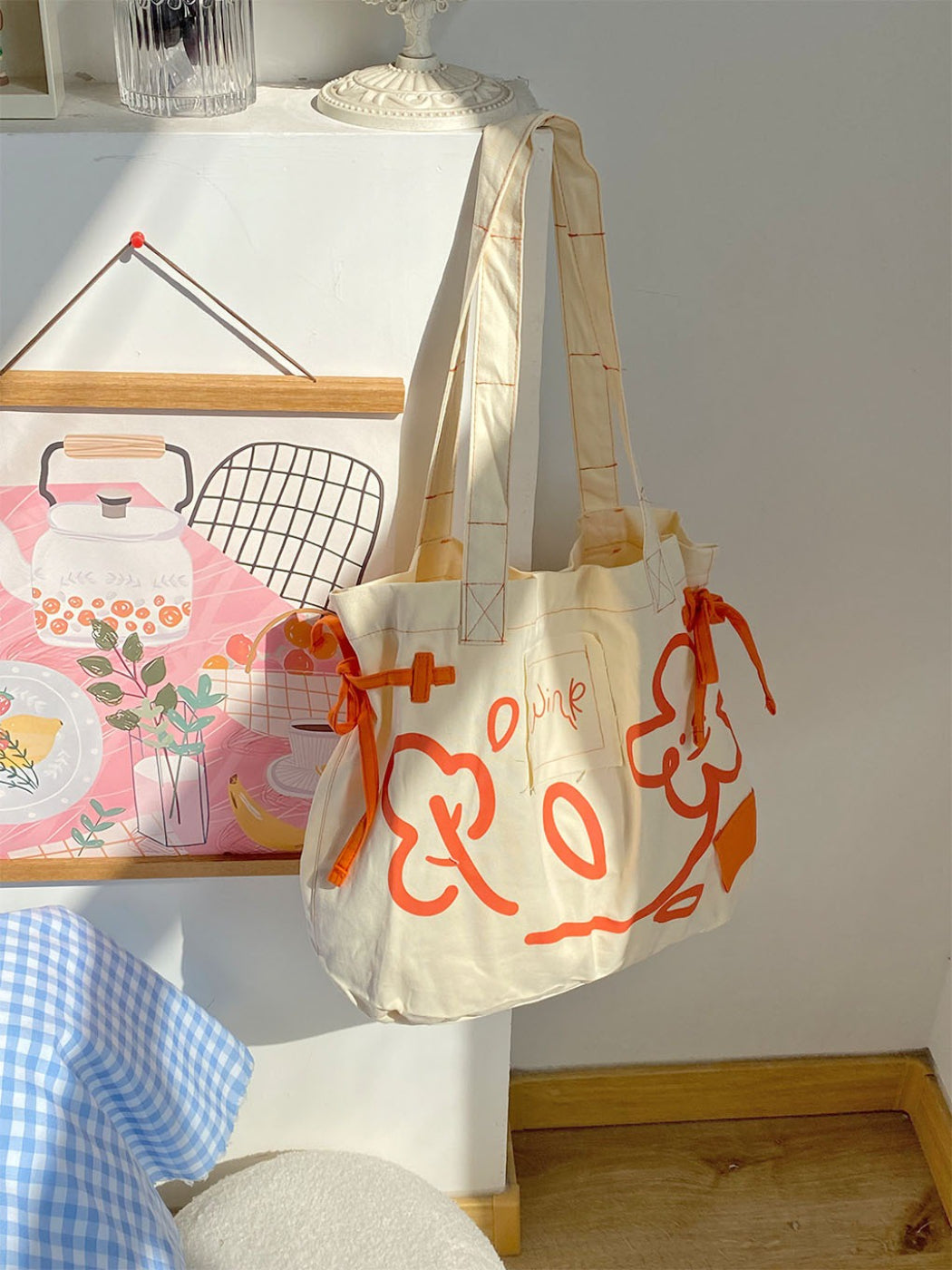 Cosbai tote bag placed on wooden surface showcasing graphic design and durable material