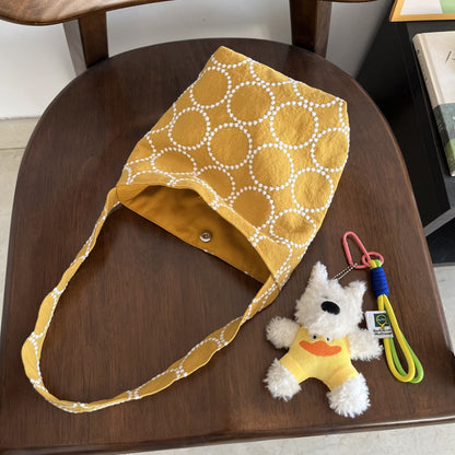Cosbai tan leather hobo bag displayed on white background highlighting shape and design
