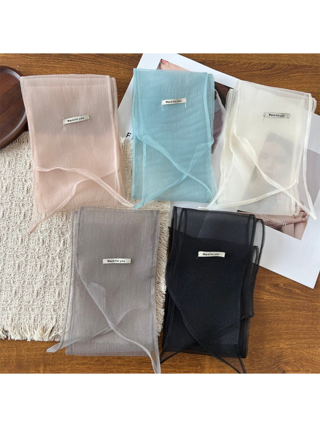 Sheer lightweight skinny scarf in soft pastel colors displayed flat on white background