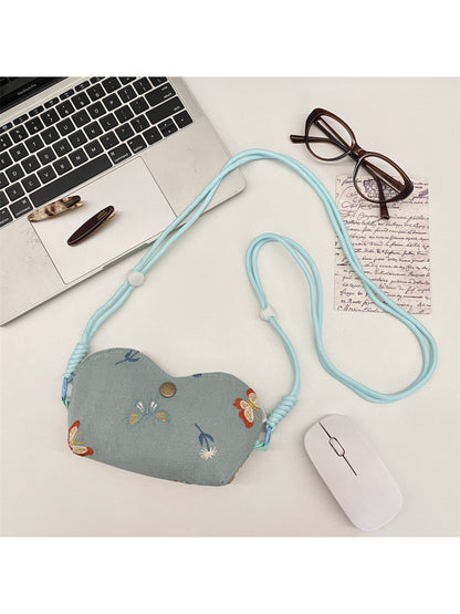 Side view of Cosbai mini floral embroidered crossbody pouch bag with strap