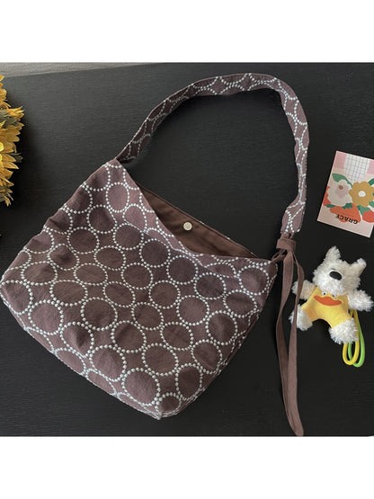 Side view of Cosbai Circle Print Tie Shoulder Bag showing bag depth and strap detail