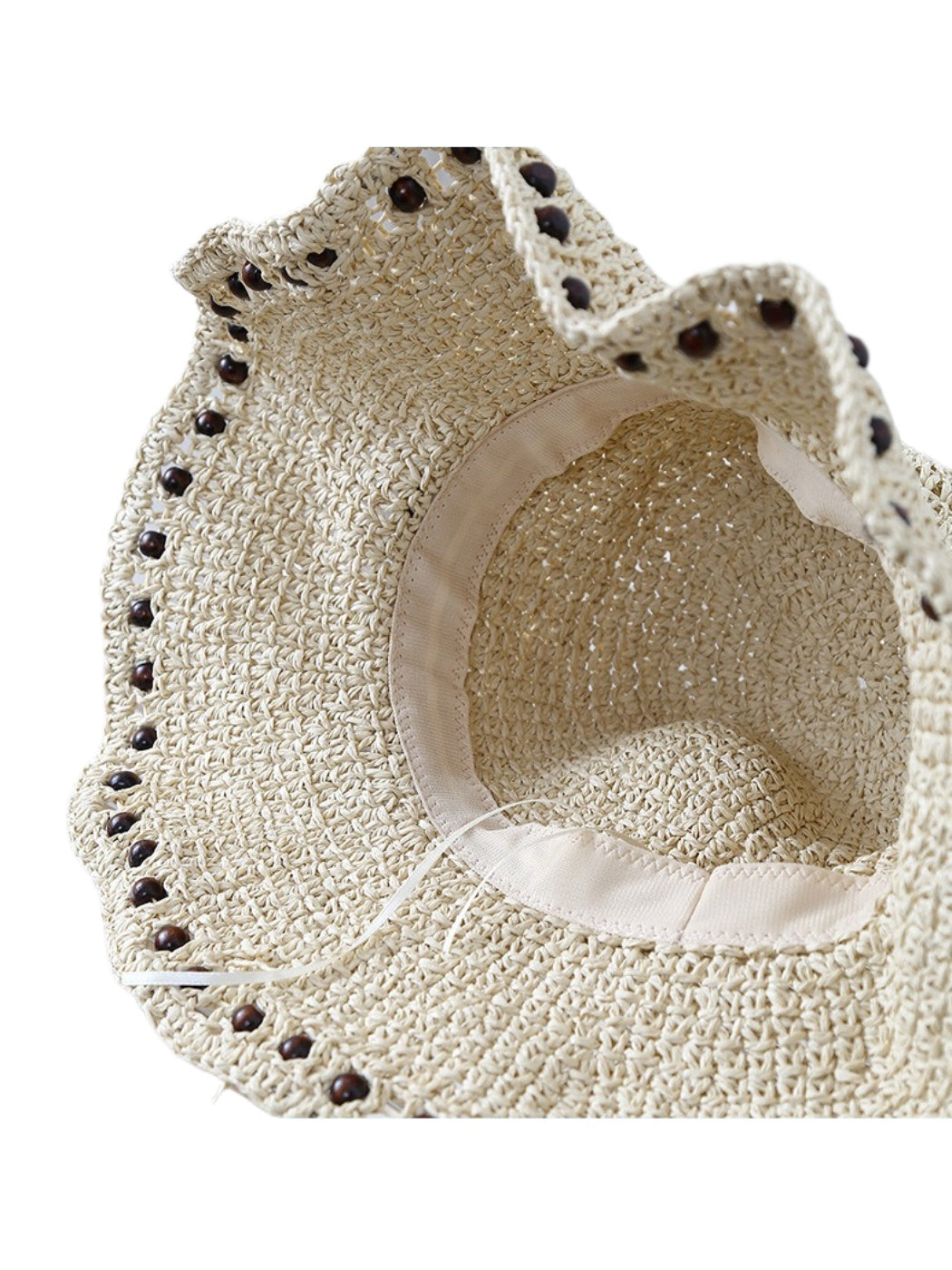 Haila crochet bucket hat with beaded edge displayed on flat surface