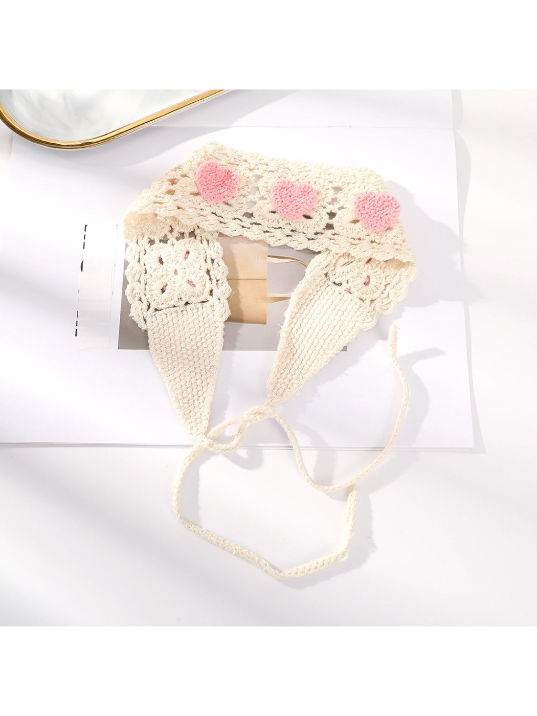 Scarvii crochet heart tie headband in soft yarn with heart detail on a white background