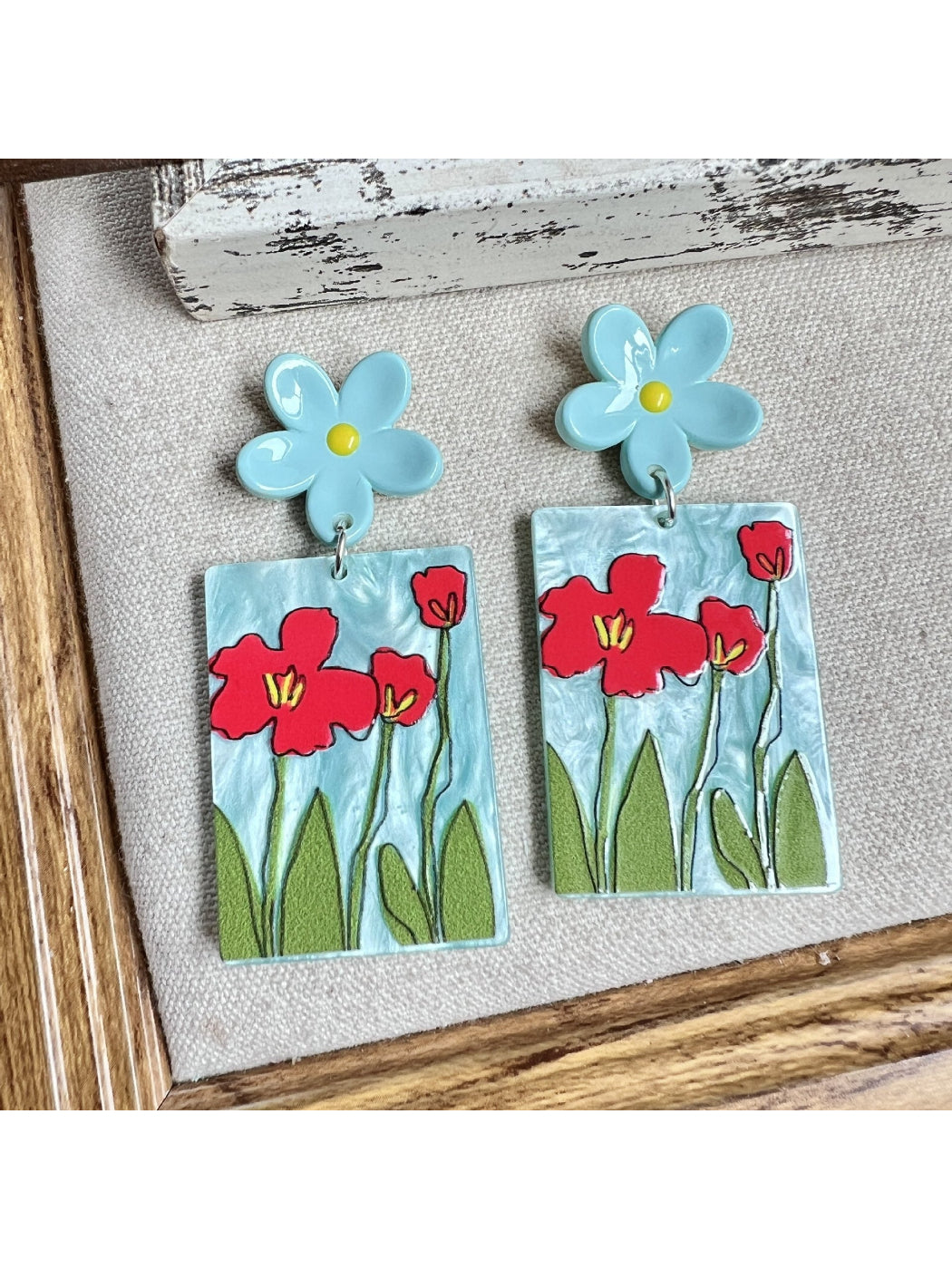 Close-up of Earwish Painted Flower Drop Earrings with pink and white floral design