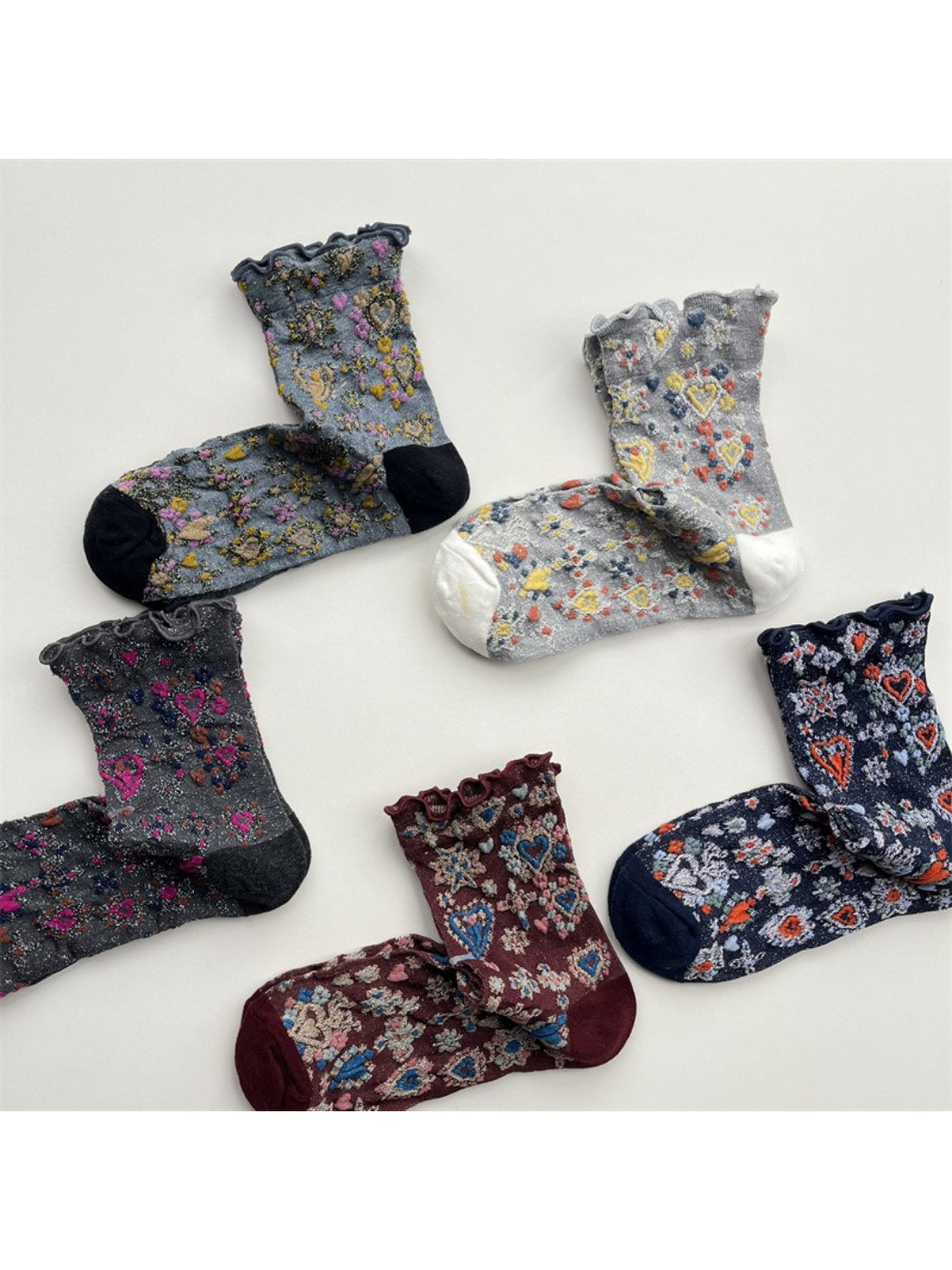 Rufia Heart White Mid-Calf Socks displayed with one sock slightly overlapping the other