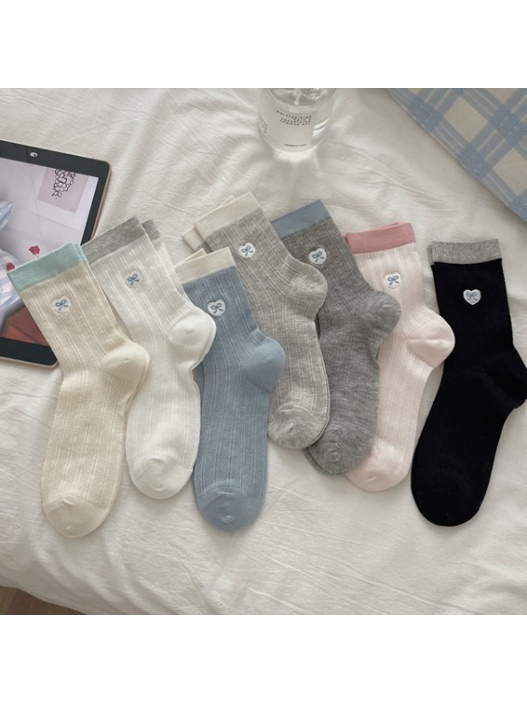 Pair of Rufia lightweight floral knit crew socks in pastel colors displayed flat
