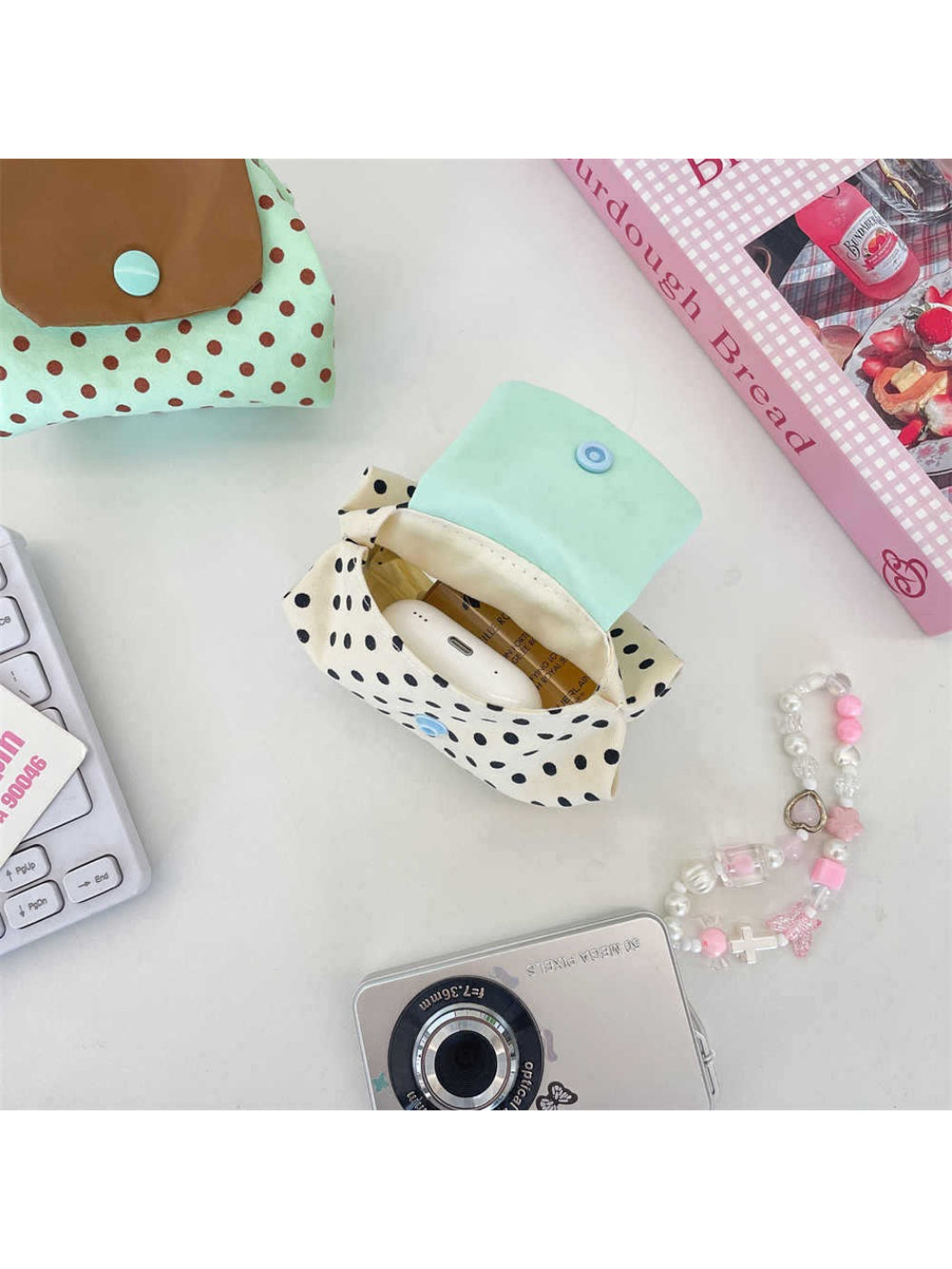 Cosbai mini polka dot pouch bag with zipper partially open showing contents