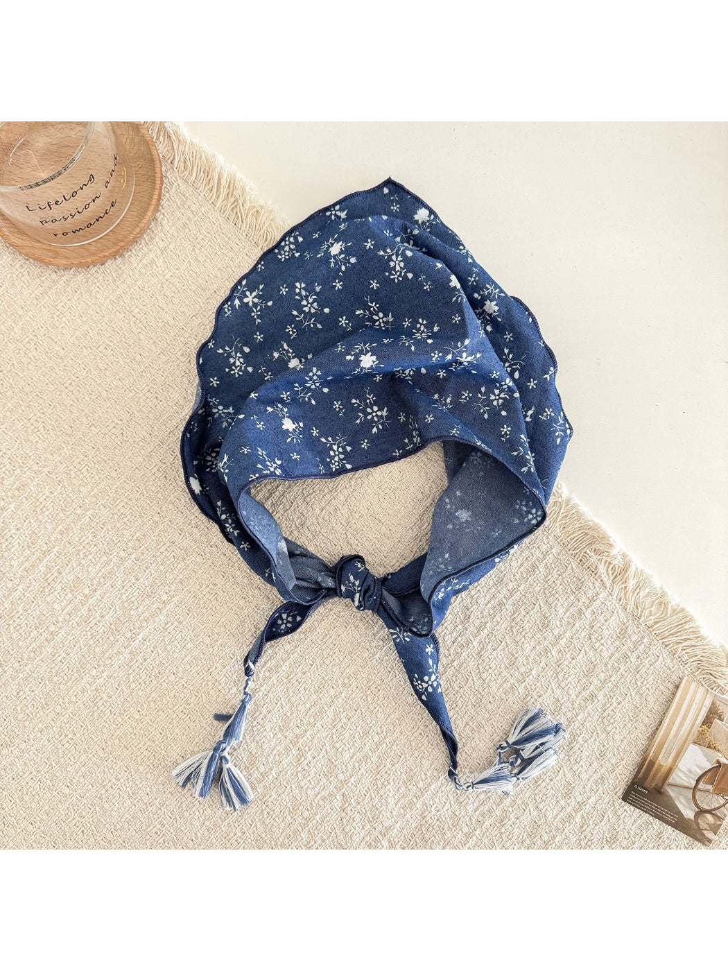 Blue floral triangle scarf styled as a head wrap with tassels