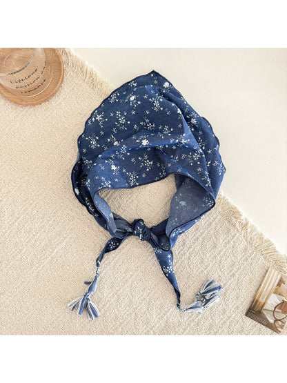 Blue floral triangle scarf styled as a head wrap with tassels