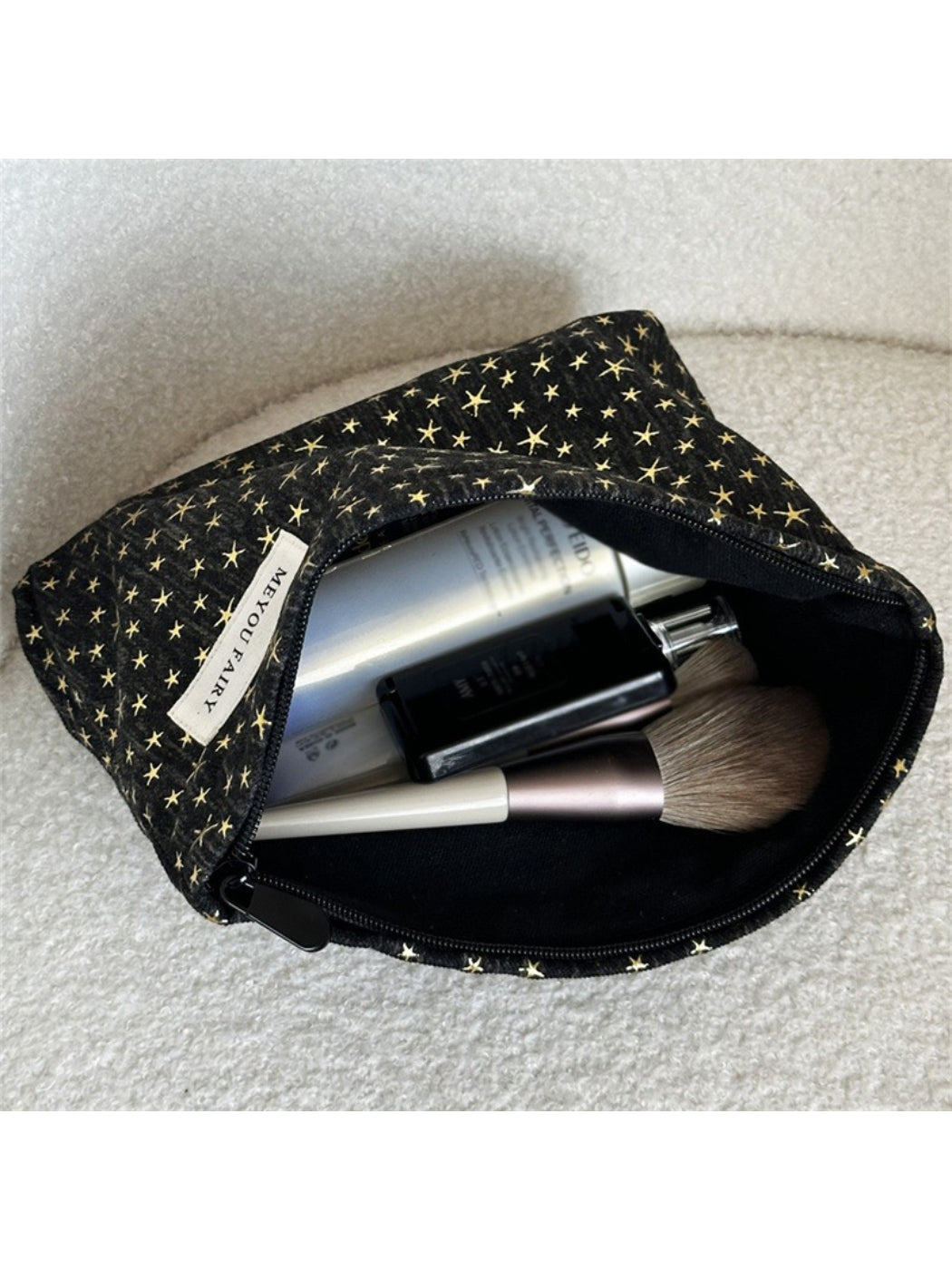 Cosbai Black Star Cosmetic Bag laying flat showing full star pattern on black surface
