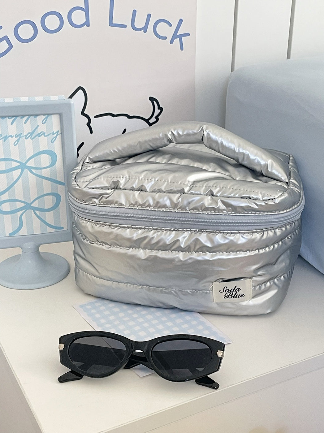 Cosbai makeup organizer bag open with various cosmetics inside