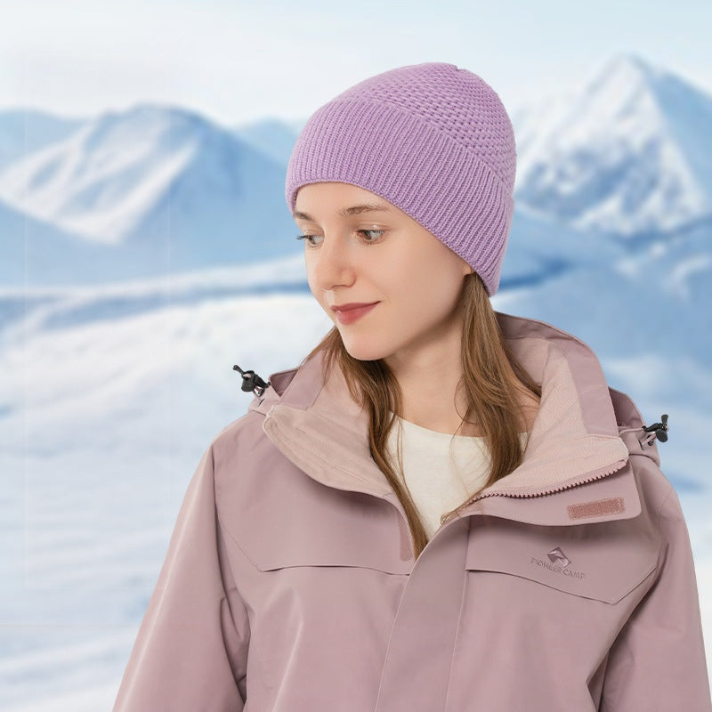 Purple ribbed cuff knit beanie shown on a model outdoors