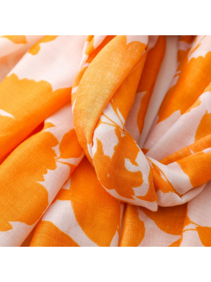 Close-up of the Floral scarf's orange print across gathered white folds