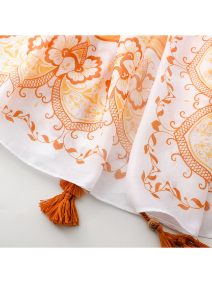 Close-up of the Medallion scarf's stitched edge and beaded orange tassels
