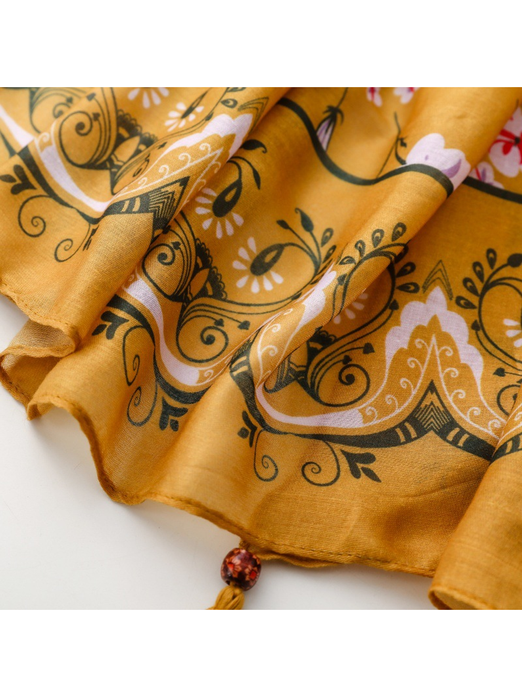 Close-up of the Paisley scarf's ornamental border and stitched edge