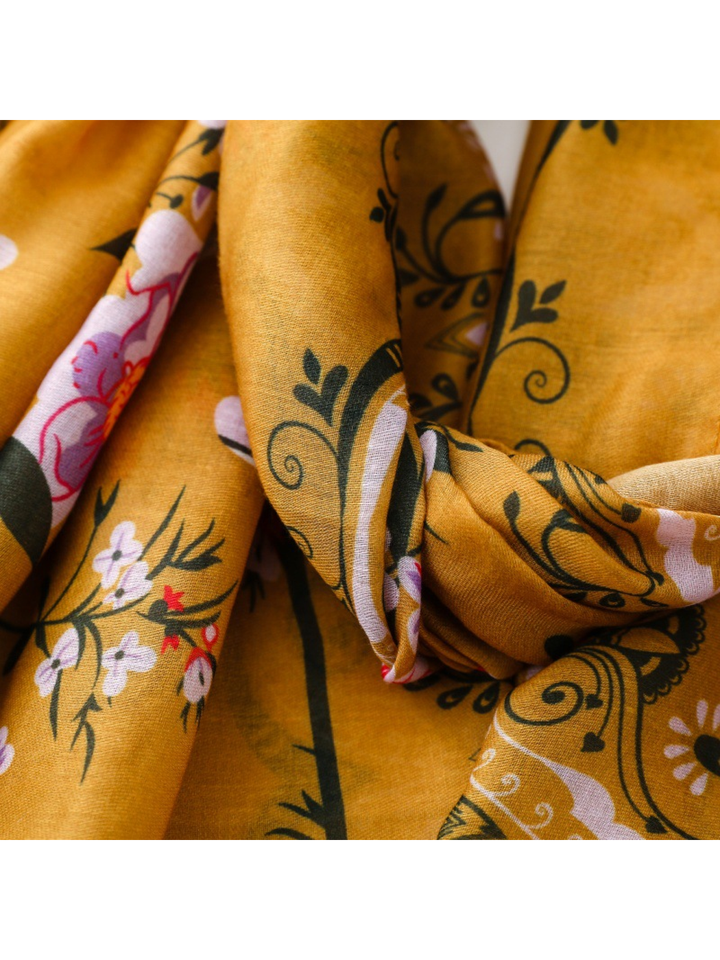 Close-up of the Paisley scarf's floral and scrolling print across folds