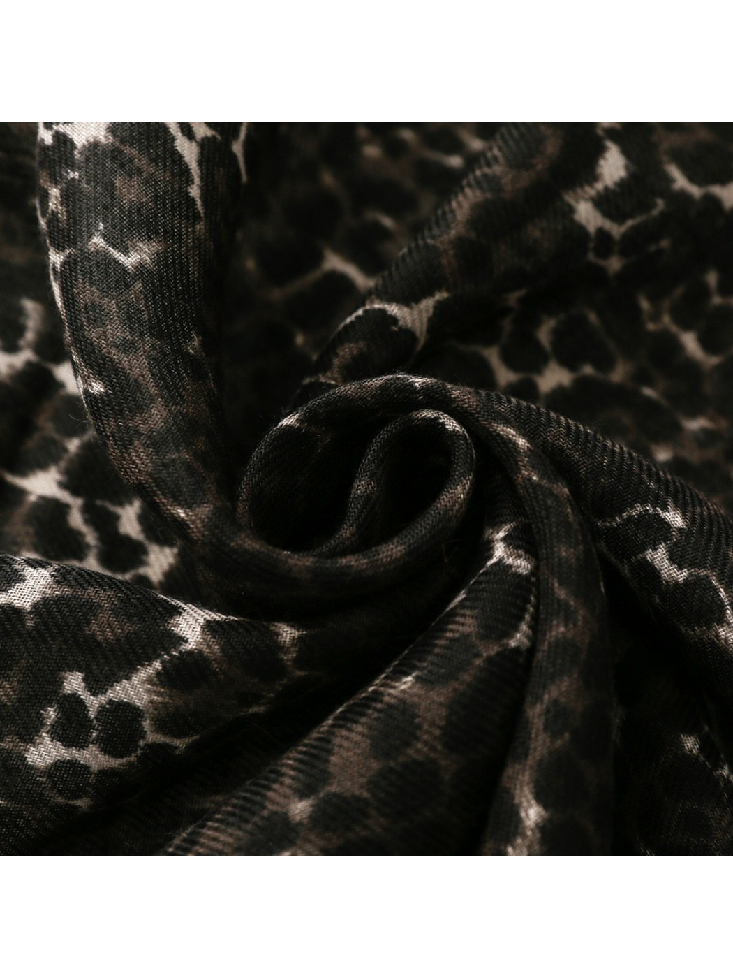 Close-up of the Black leopard-print scarf gathered into soft folds
