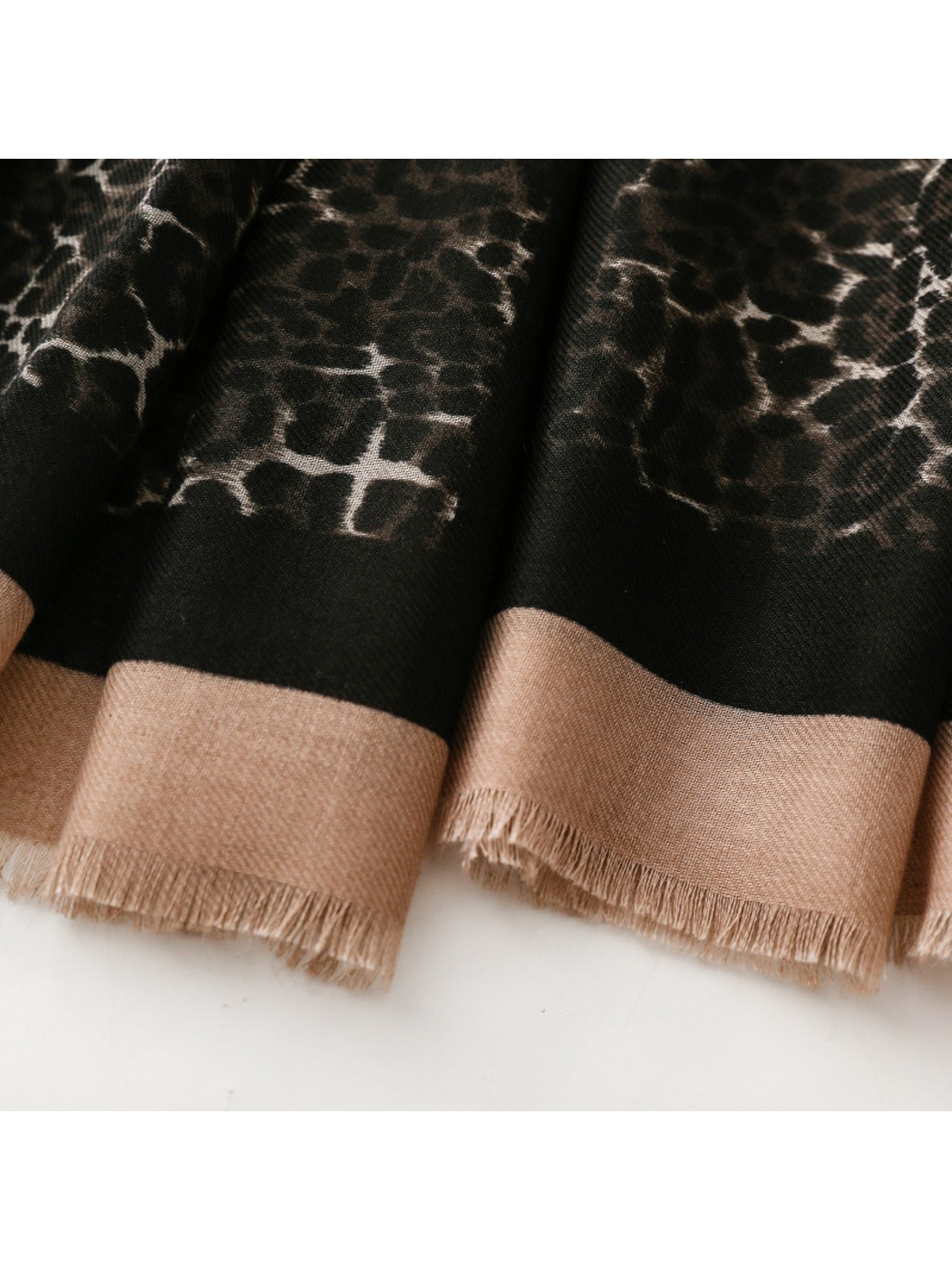 Close-up of the Black scarf's beige border and short fringe