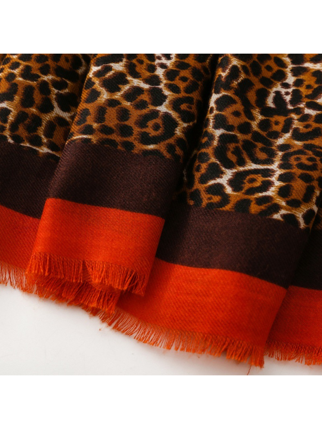 Close-up of the Brown scarf's dark brown and orange fringed border