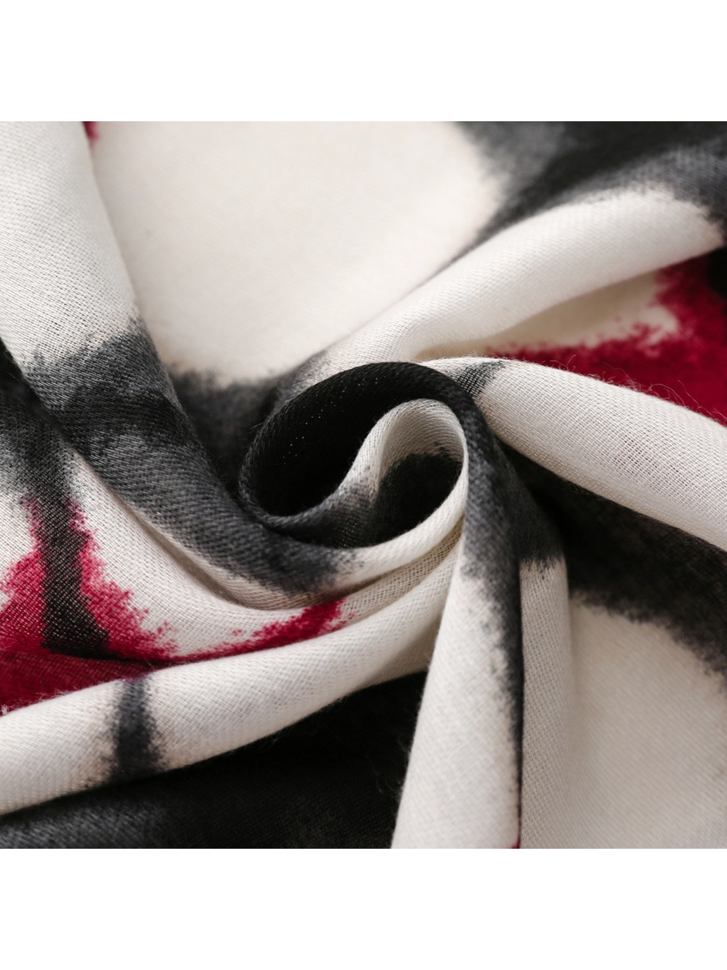 Close-up of abstract floral scarf curled into soft folds