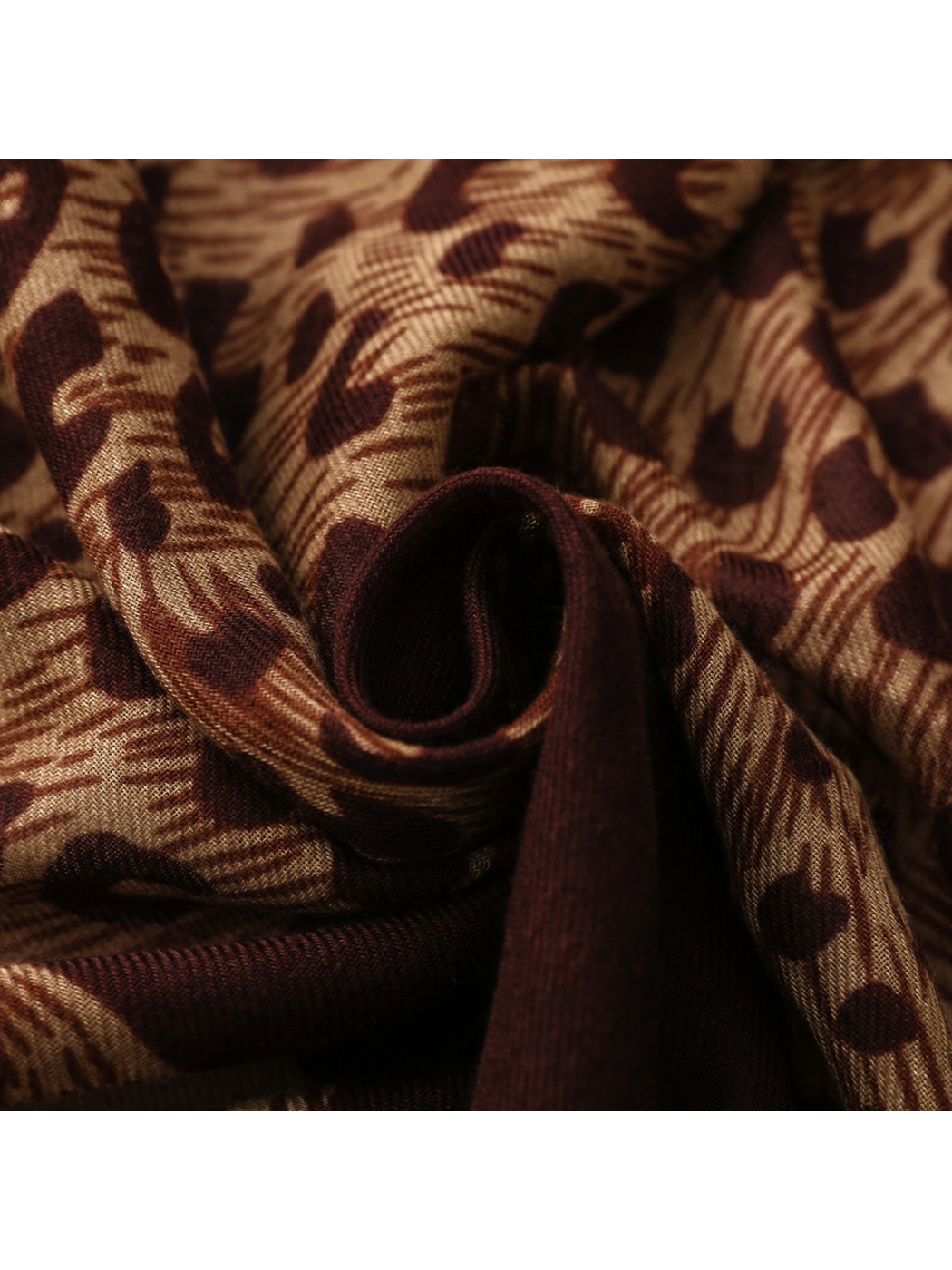 Close-up of Leopard scarf gathered burgundy and tan spotted folds