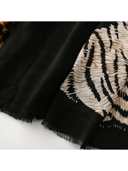 Close-up of Tiger scarf short black fringe beside the cream motif