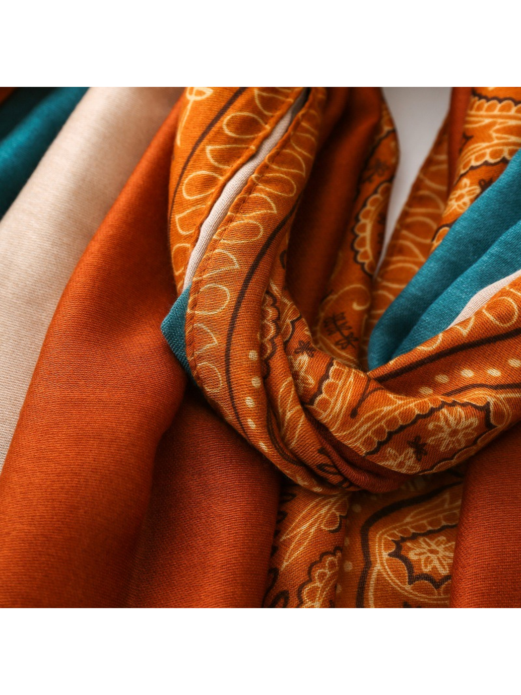 Close-up of teal and cream panels meeting the orange printed border