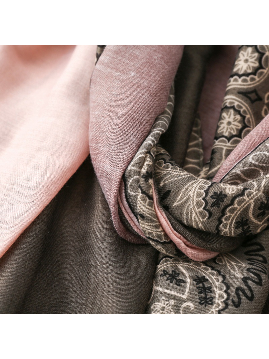 Close-up of pale pink and mauve panels beside the gray paisley border