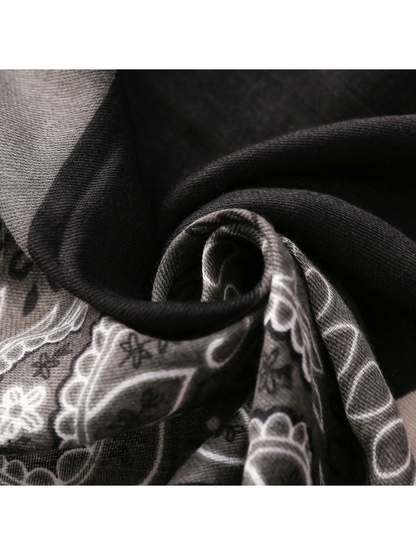 Close-up of the black and gray scarf's fine woven texture and curved folds