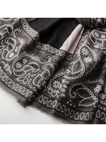 Close-up of short gray fringe beneath the black paisley border