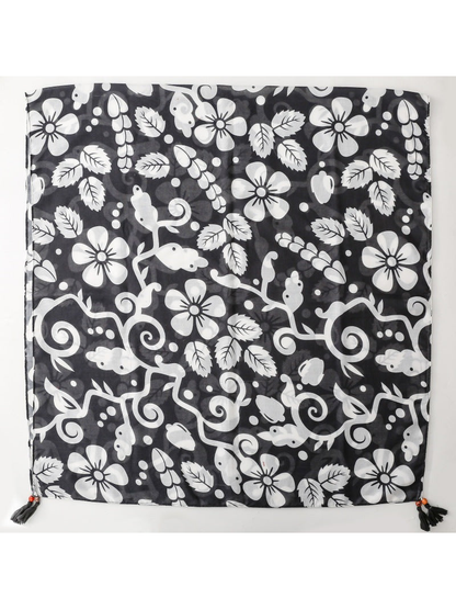 SL2607-055 black and white botanical and animal motif scarf laid flat with corner tassels