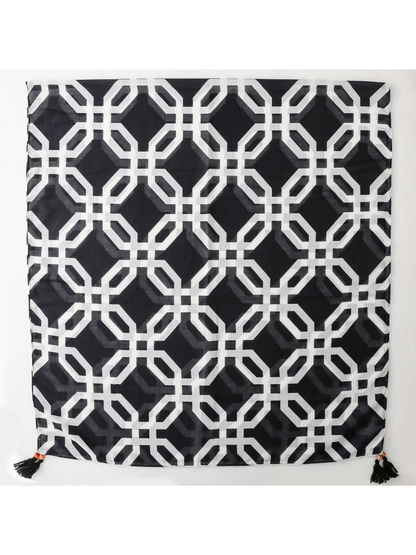 SL2607-056 black and white geometric lattice scarf laid flat with corner tassels