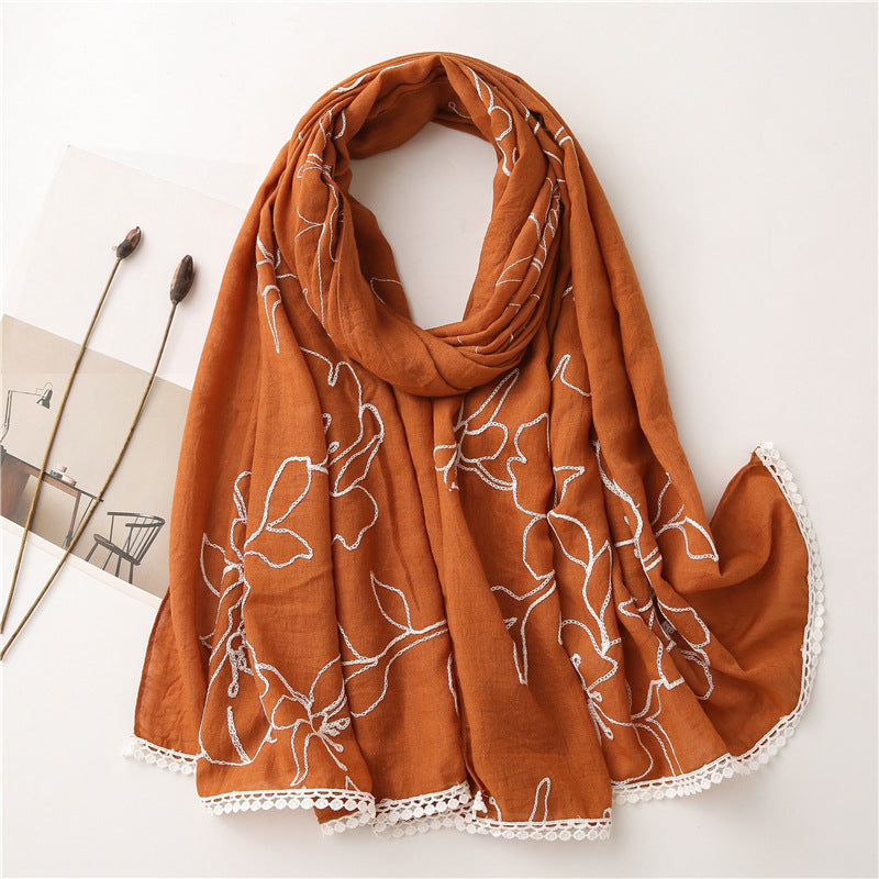 Orange floral embroidered lace trim shawl in a draped product view