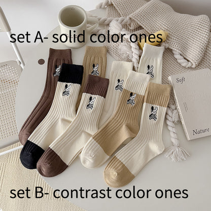 Four pairs of Rufia socks displayed flat showing different bunny embroidery patterns