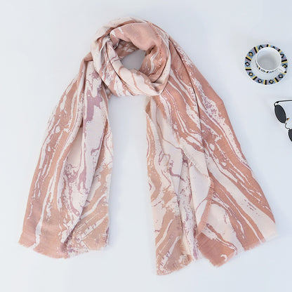 Scarvii marble long scarf wrapped around shoulders of model outdoors