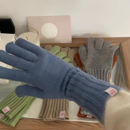 Model showing flexibility of gray knitted gloves with extended sleeves