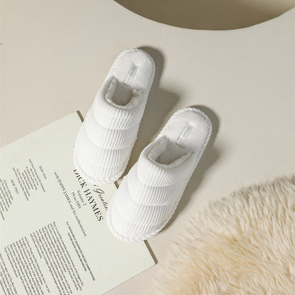 Top view of a pair of brown corduroy slippers showing cushioned interior