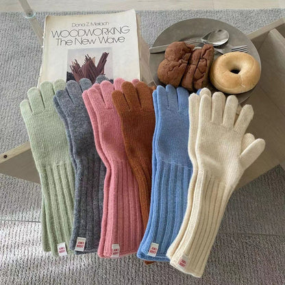Close-up of winter knitted glove with extended sleeve in gray color
