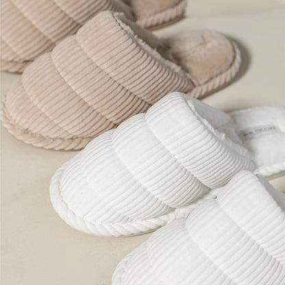 Side view of a brown corduroy slipper highlighting the sole and stitching