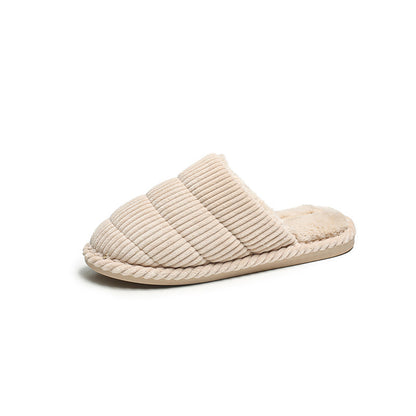 Brown corduroy slippers displayed with a casual outfit on a chair